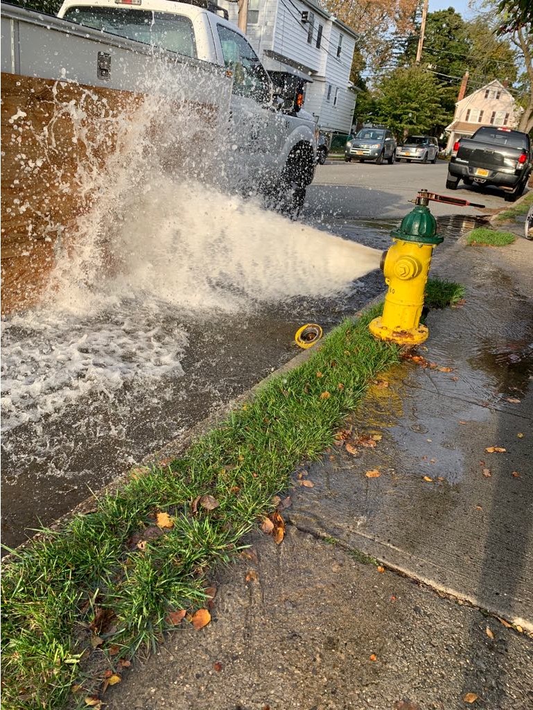 fire hydrant shooting water at a car